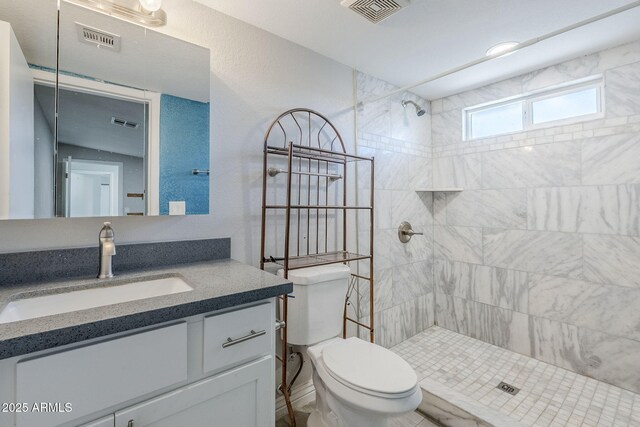 7135 W Flower St, Phoenix, AZ 85033 - bathroom featuring toilet, tiled shower, and vanity