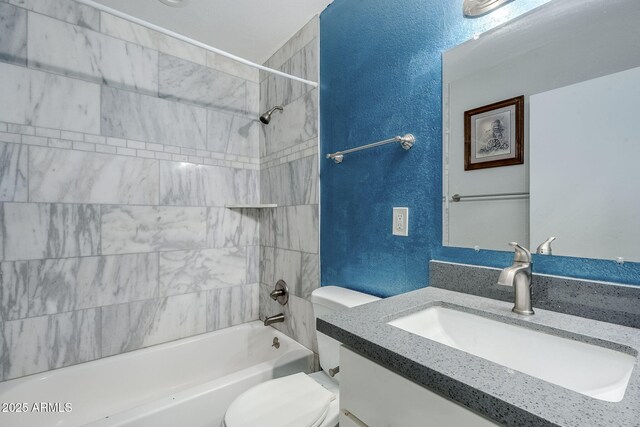 7135 W Flower St, Phoenix, AZ 85033 - full bath featuring toilet, a textured wall, vanity, and shower / tub combination