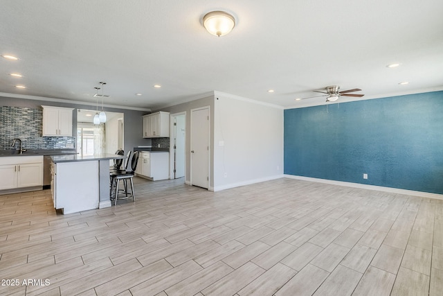 7135 W Flower St, Phoenix, AZ 85033 - kitchen featuring open floor plan, a center island, ceiling fan, crown molding, and a sink