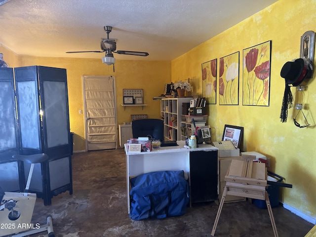 office area with baseboards, a textured ceiling, a ceiling fan, and concrete flooring