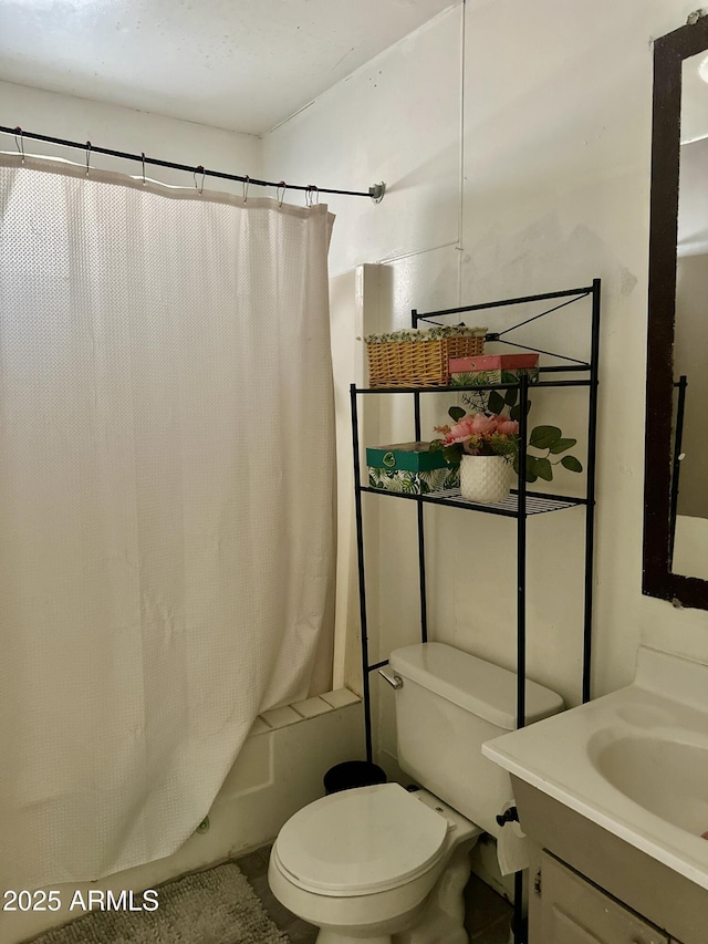 bathroom with shower / tub combo, vanity, and toilet