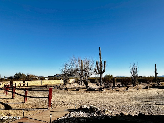 view of yard featuring fence and a rural view