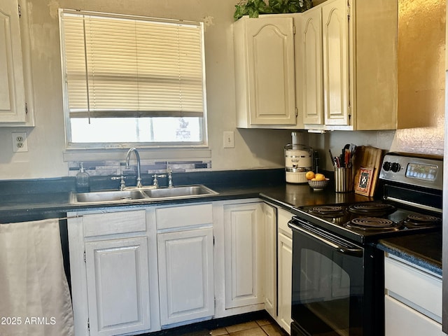 kitchen featuring dark countertops, dishwasher, electric range, and a sink