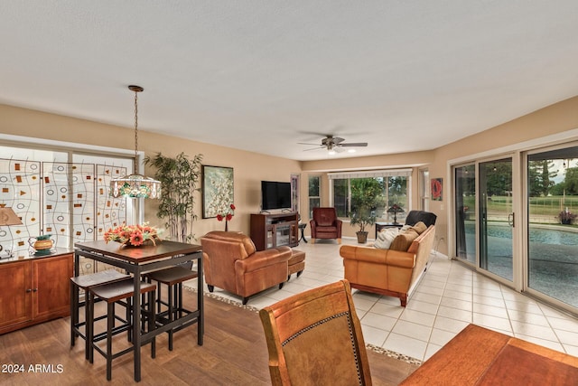 tiled living room with ceiling fan