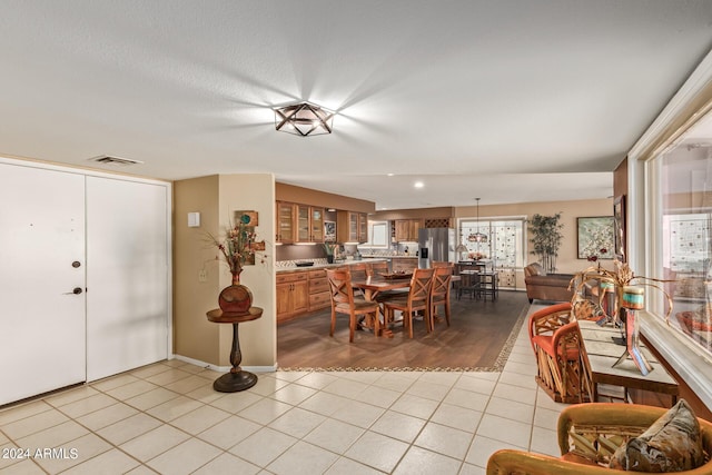 interior space with light tile patterned floors and a textured ceiling