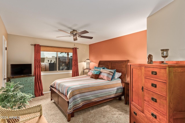 bedroom featuring light colored carpet and ceiling fan