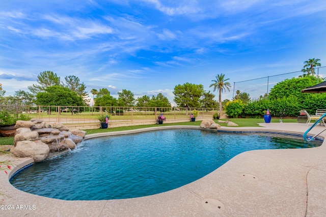 view of pool featuring pool water feature and a patio