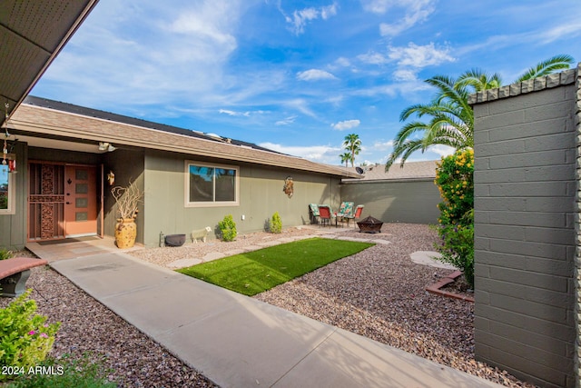 exterior space featuring a patio and a fire pit