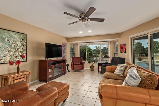 living room with ceiling fan and light tile patterned flooring