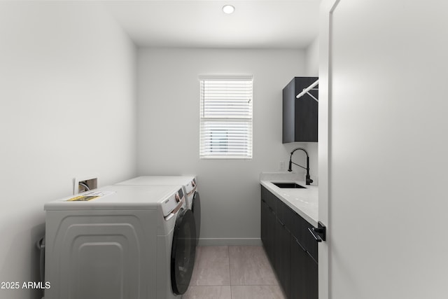 laundry area with cabinets, sink, washer and dryer, and light tile patterned floors