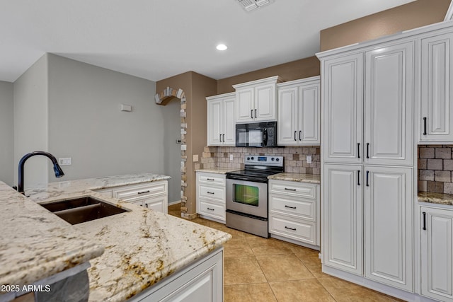 kitchen featuring light tile patterned flooring, sink, white cabinets, electric range, and light stone countertops