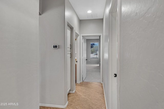 corridor with light tile patterned floors