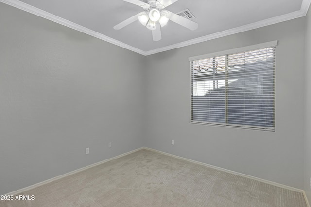 carpeted empty room featuring crown molding and ceiling fan