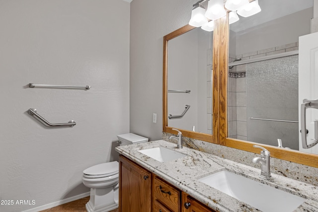 bathroom with walk in shower, vanity, and toilet