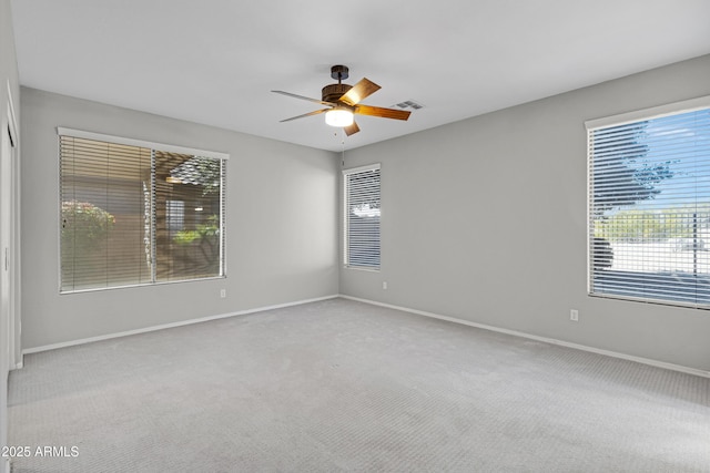 empty room featuring light carpet and ceiling fan