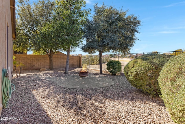 view of yard with a patio and a fire pit