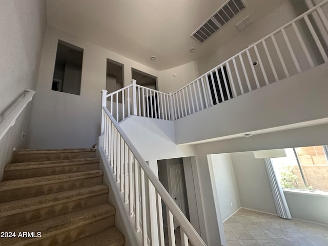 stairs featuring a high ceiling