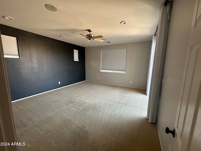 empty room with carpet flooring and ceiling fan