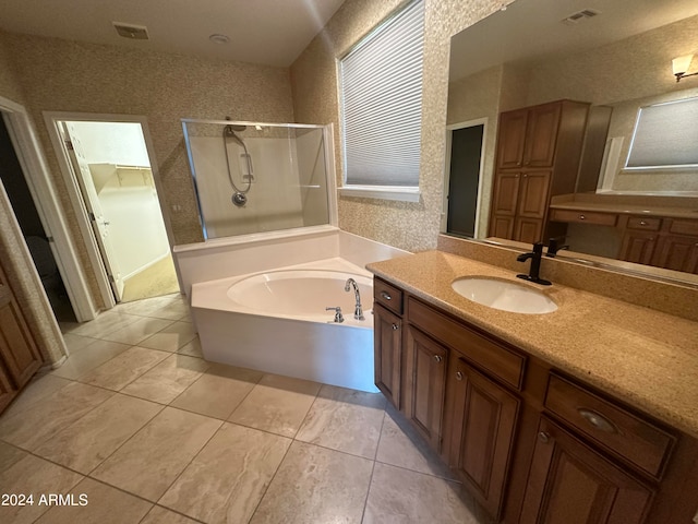 bathroom featuring tile patterned floors, separate shower and tub, and vanity