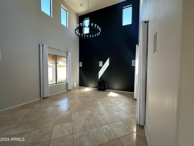 interior space with a high ceiling and a chandelier