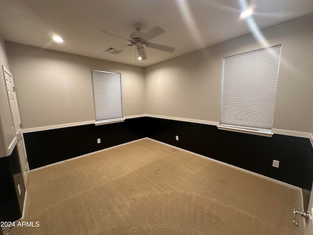 carpeted spare room with ceiling fan