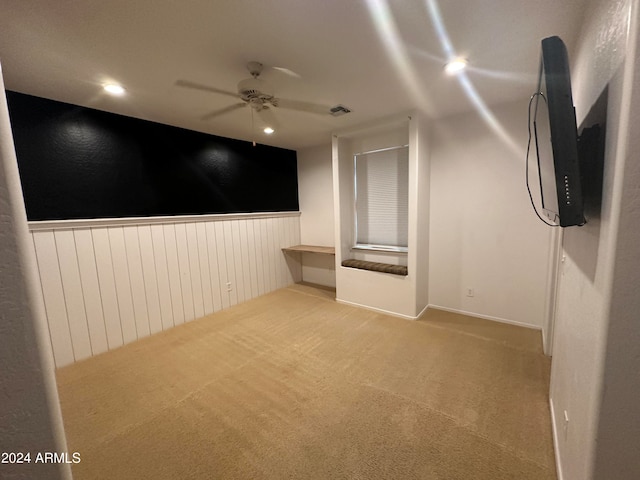 spare room featuring light carpet and ceiling fan