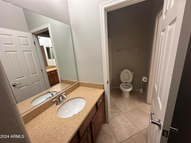 bathroom with vanity, tile patterned flooring, and toilet