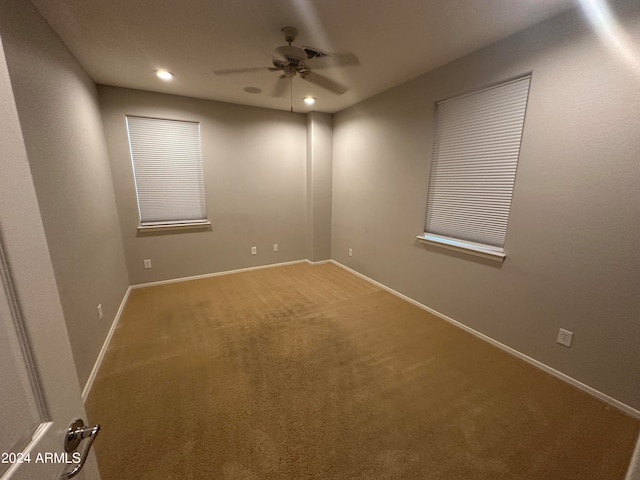 empty room featuring ceiling fan and carpet floors