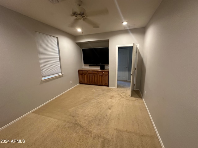 interior space with ceiling fan