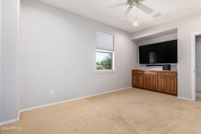 unfurnished living room with ceiling fan and light colored carpet