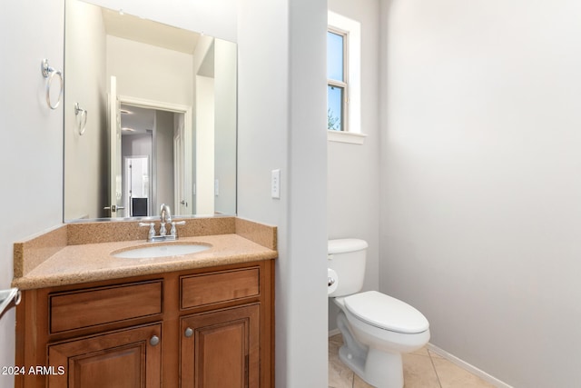 bathroom featuring vanity, tile patterned flooring, and toilet