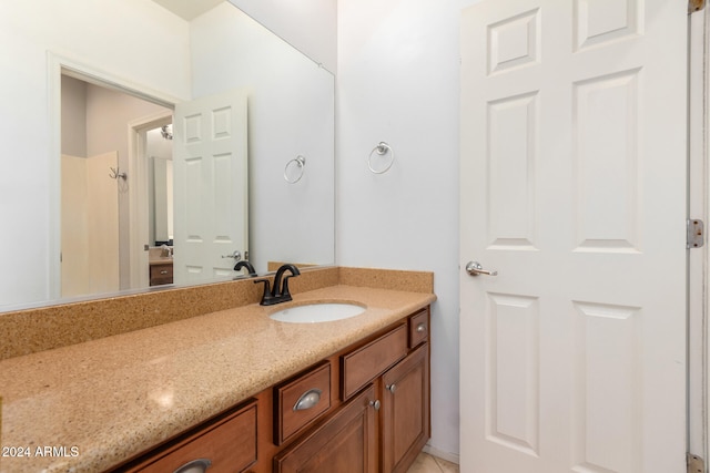 bathroom featuring tile patterned flooring and vanity