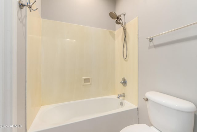 bathroom featuring tub / shower combination and toilet