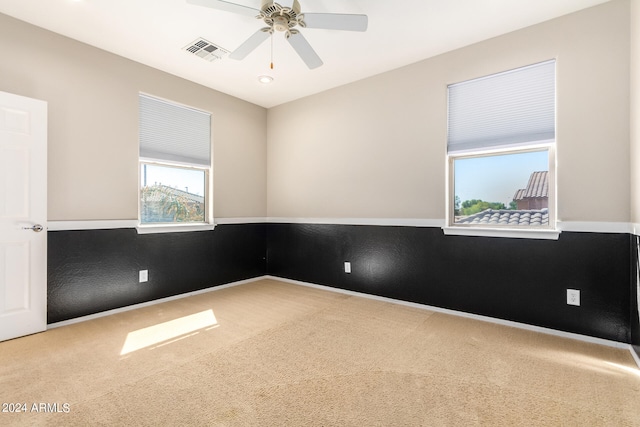 spare room featuring carpet floors and ceiling fan