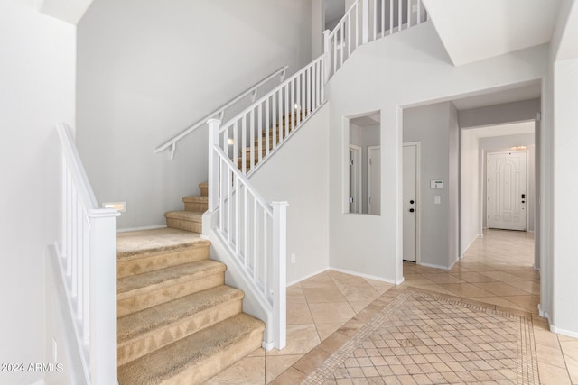 stairs featuring tile patterned flooring