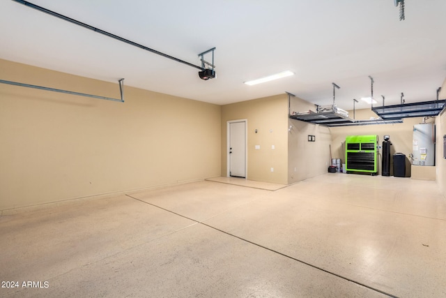 garage with gas water heater and a garage door opener