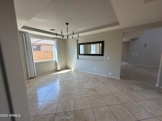 unfurnished dining area featuring a tray ceiling, an inviting chandelier, and light tile patterned floors