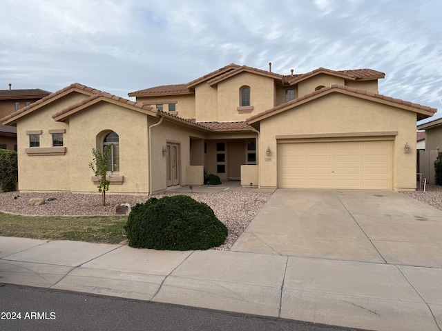 mediterranean / spanish-style home with a garage