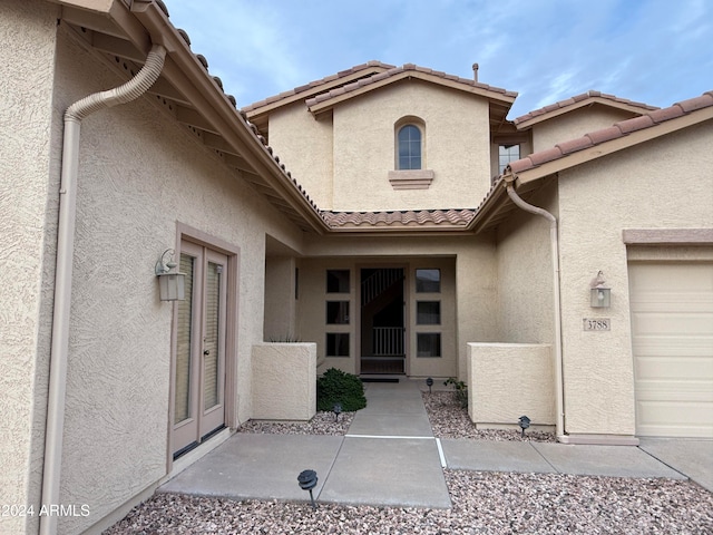 view of exterior entry featuring a garage