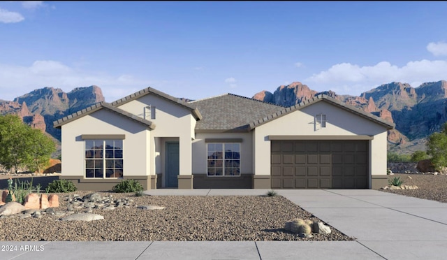 view of front of property featuring a garage and a mountain view