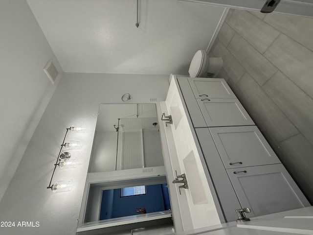 full bath featuring toilet, walk in shower, and visible vents