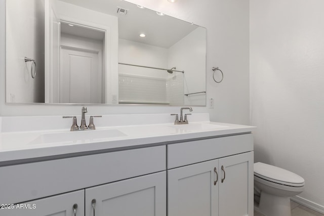 full bath with double vanity, toilet, a shower, and a sink