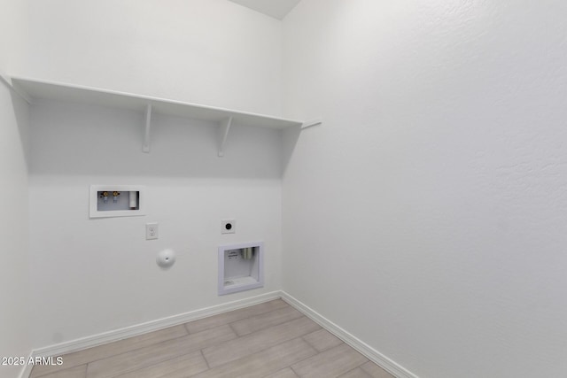 laundry area with gas dryer hookup, baseboards, electric dryer hookup, laundry area, and washer hookup