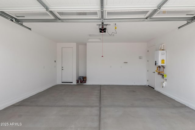 garage featuring water heater, baseboards, and a garage door opener