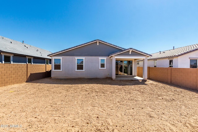 rear view of property featuring a fenced backyard