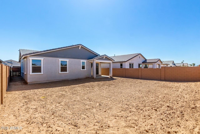 back of property featuring a fenced backyard
