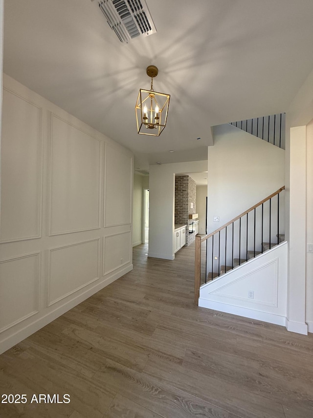 26655 S 169th Pl, Queen Creek, AZ 85142 - interior space with an inviting chandelier, stairway, visible vents, a decorative wall, and wood finished floors