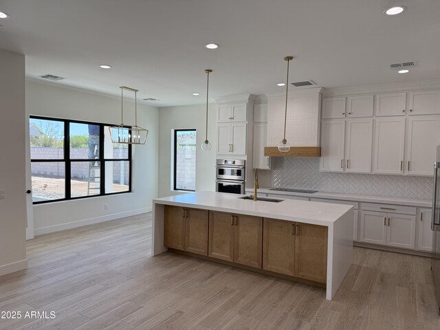 26655 S 169th Pl, Queen Creek, AZ 85142 - kitchen featuring a sink, visible vents, light countertops, and black electric cooktop