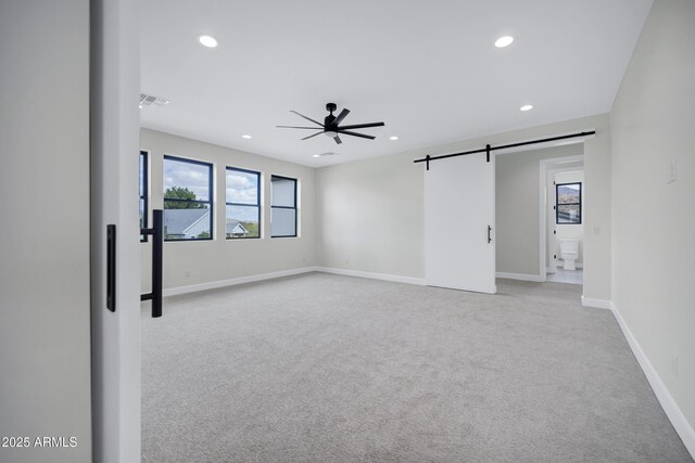 26655 S 169th Pl, Queen Creek, AZ 85142 - spare room featuring a wealth of natural light, a barn door, visible vents, light colored carpet, and ceiling fan