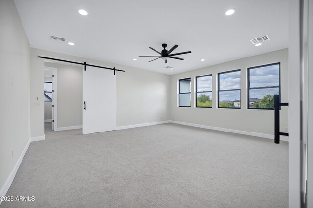 26655 S 169th Pl, Queen Creek, AZ 85142 - empty room with a barn door, ceiling fan, light carpet, visible vents, and recessed lighting